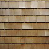 A close up of the wood shingles on a house.