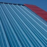 A blue and red roof with a sky background