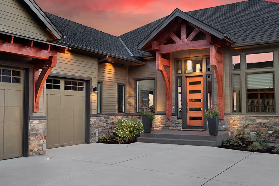 A house with a garage and a door open.