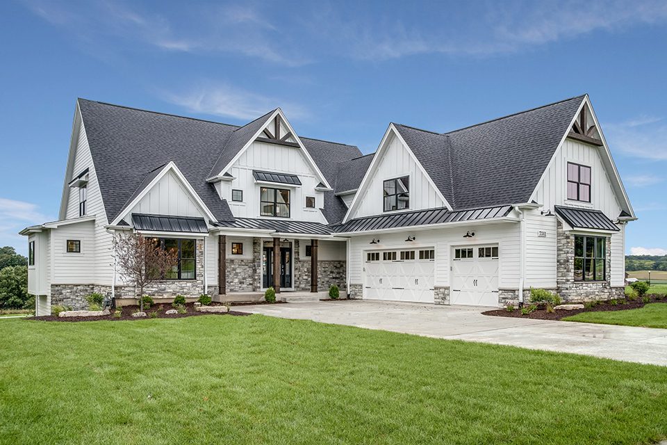 A large white house with a lawn in front of it.